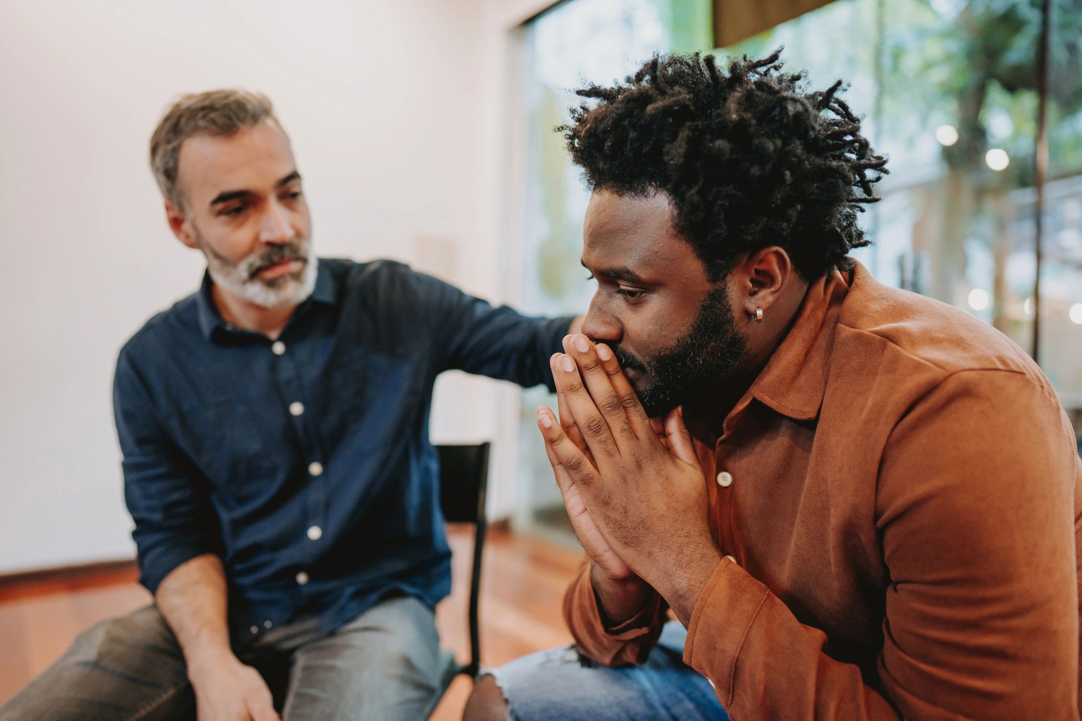 Group therapy session with people supporting each other